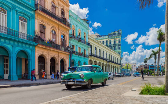 Cityscape with american green vintage car on the main street in Havana City Cuba - Serie Cuba Reportage